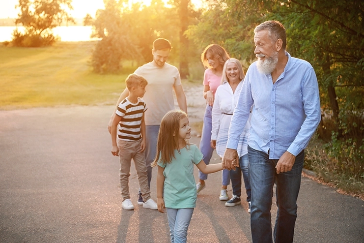 Father Walking With His Children And Grandchildren