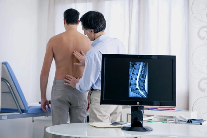 Orthopedist Examining-Back After Medical Imaging Study